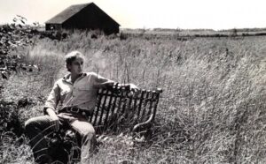 Image of Robert Dash lounging on a bench.
